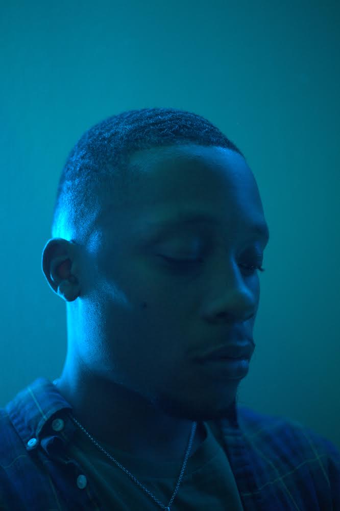 Portrait of Kiani Belgrave-Williams in blue lighting.